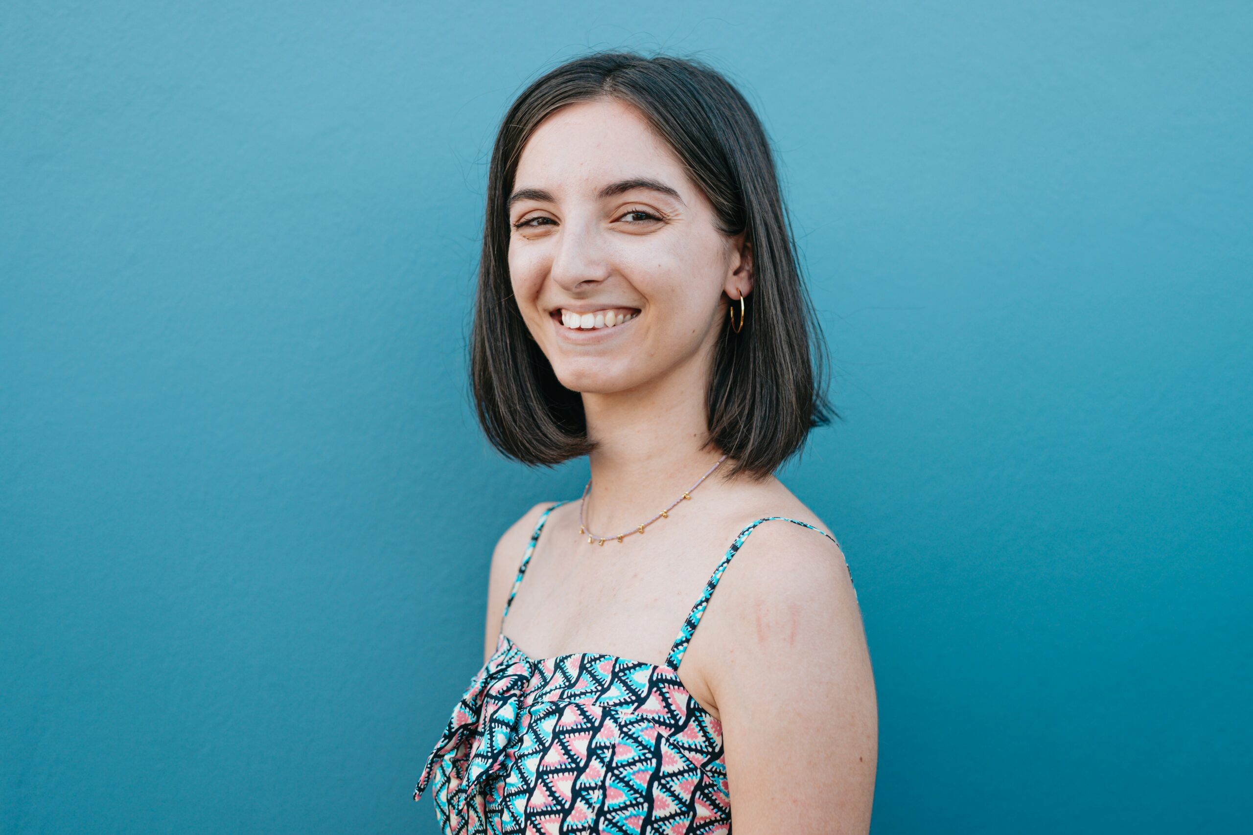 Woman with blunt bob haircut on blue background