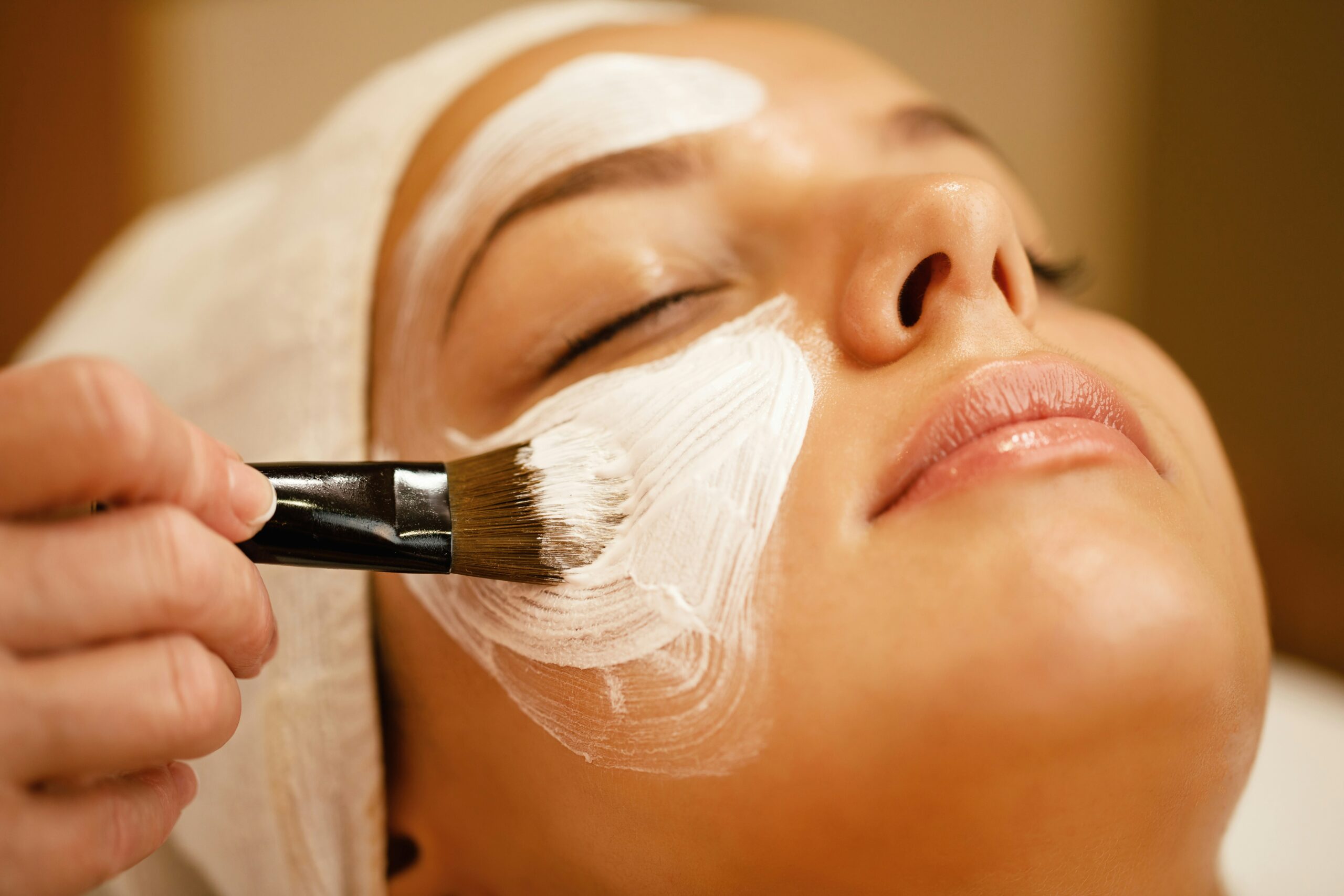 Woman receiving a skincare layering treatment