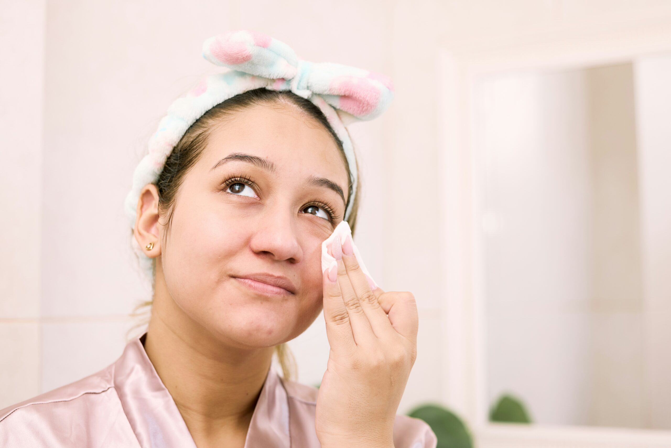 Woman in the bathroom removing makeup