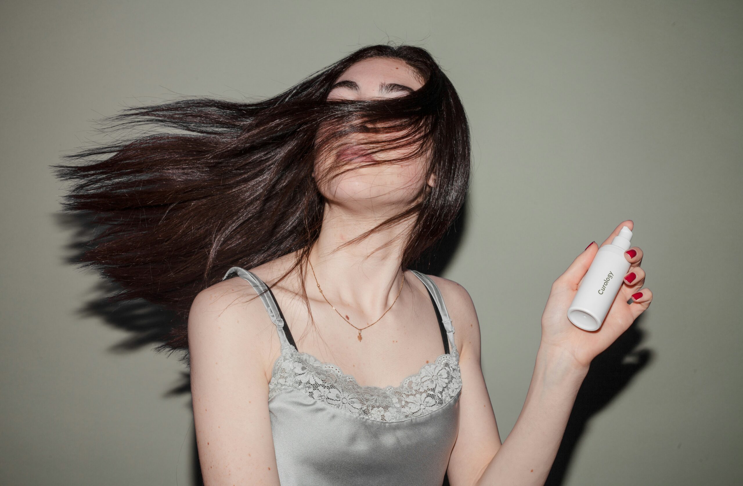 Woman showing her hair and a product
